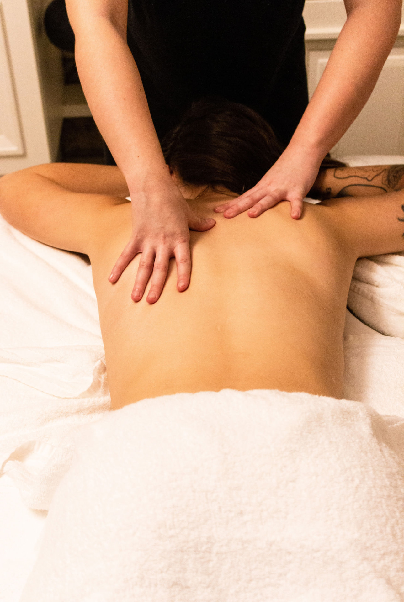 Deep tissue back massage in a warm treatment room